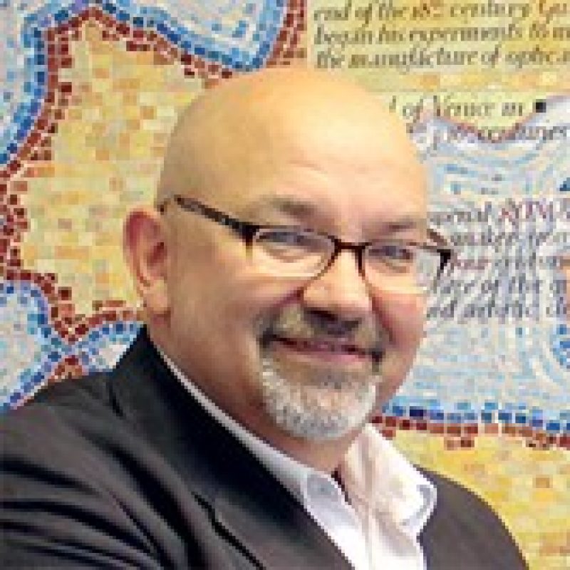 a person wearing glasses smiling